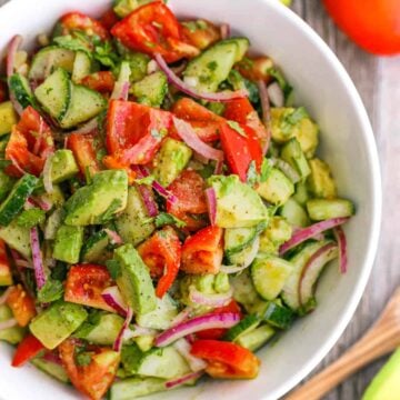 Cucumber Tomato Avocado Salad in white serving bowl