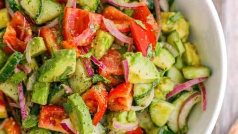 Cucumber Tomato Avocado Salad in white serving bowl