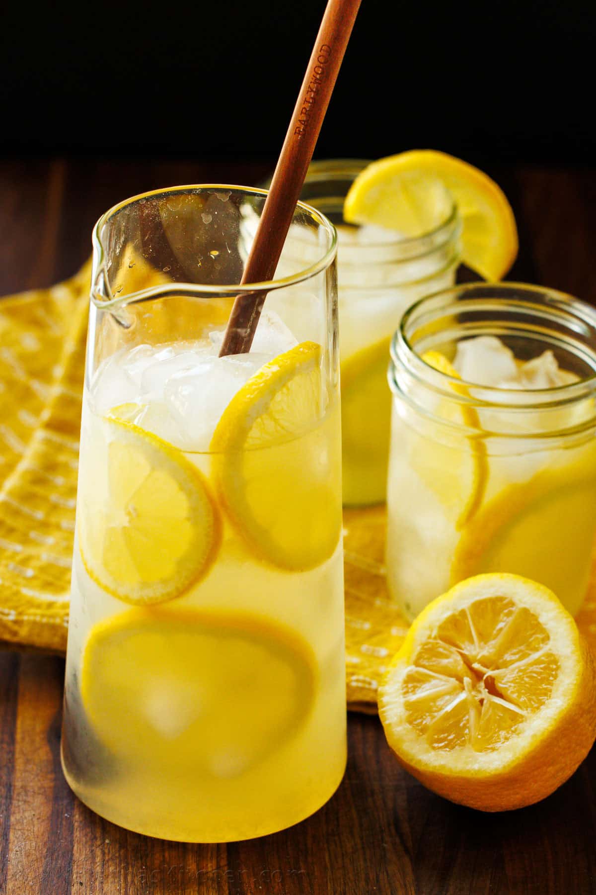 Our Lemonade recipe is so refreshing and easy with just 2 ingredients! Once you try homemade lemonade, it will spoil you forever. Homemade Lemonade recipe over ice with lemon rounds and mason jars