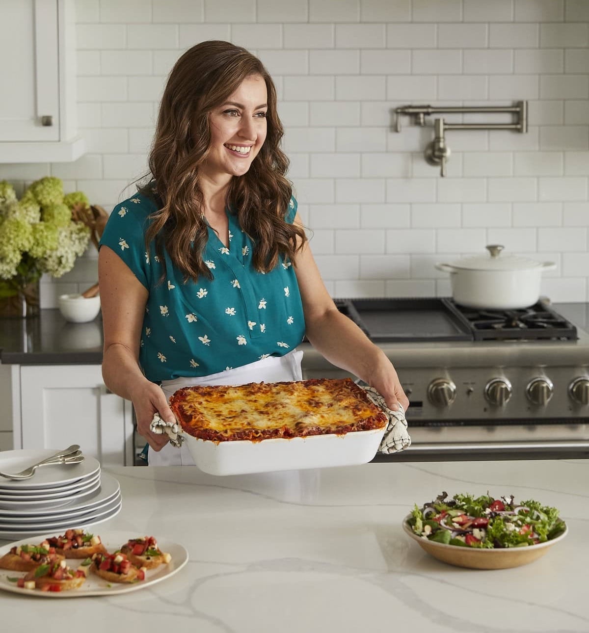 Natasha Kravchuk of Natasha's Kitchen holding casserole dish