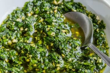 homemade chimichurri sauce in a white serving bowl