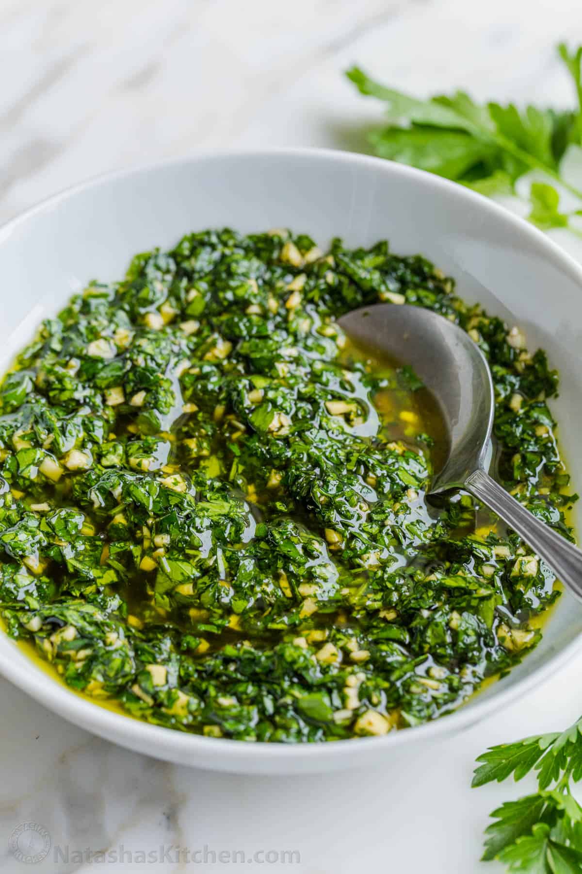 homemade chimichurri sauce in a white serving bowl