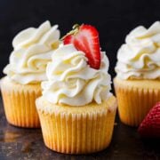Cupcake frosting piped over vanilla cupcakes