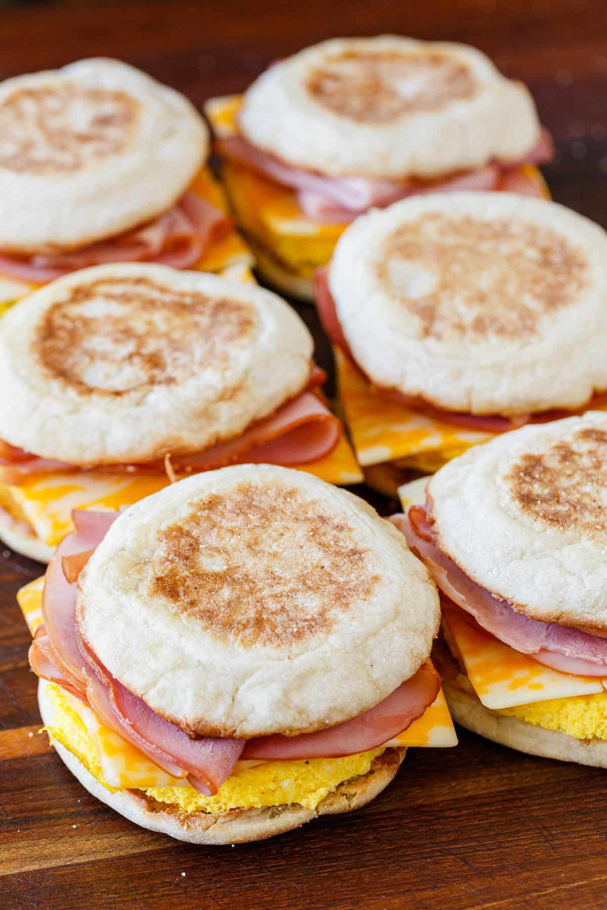 Freezer breakfast sandwiches arranged on a cutting board reading for storage
