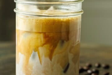 Salty Canadian Iced Latte with espresso beans and salt on the table