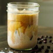 homemade Iced Latte in a mason jar with ice and maple syrup