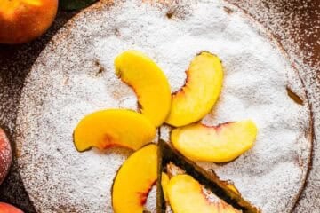 Fresh Peach Cake garnished with peach slices