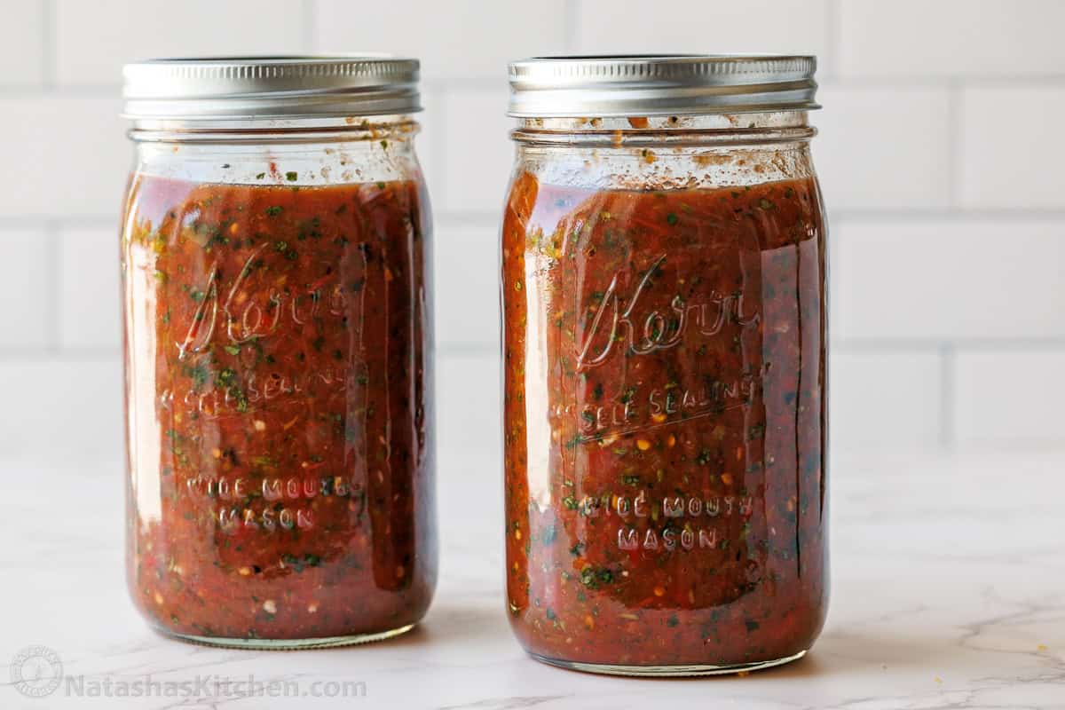 Easy Roasted tomato Salsa with smoky fire-roasted flavor, fresh cilantro, and a scoopable texture. Freezer-friendly and better than store-bought. mason jars with homemade roasted tomato salsa