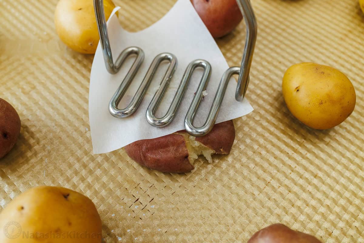using a masher on a sheet pan to make finger-food appetizer recipe