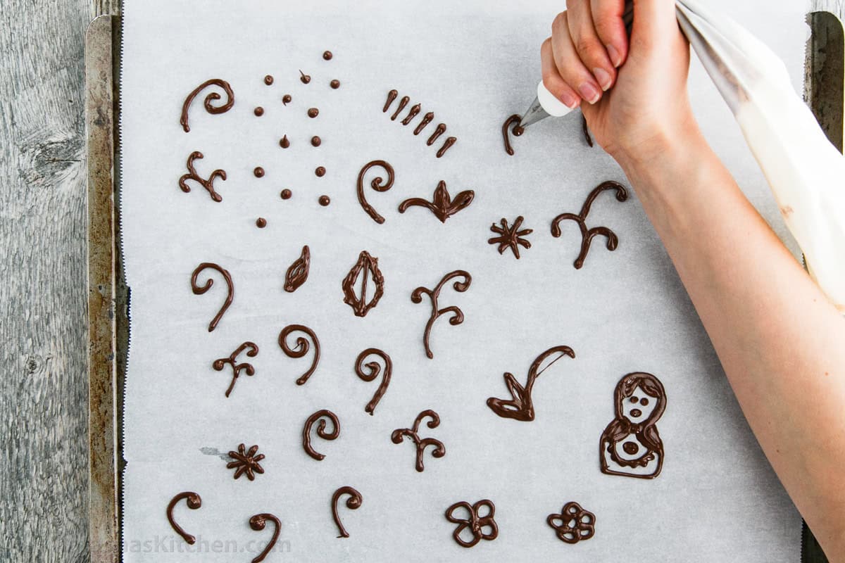 Piping chocolate onto parchment paper