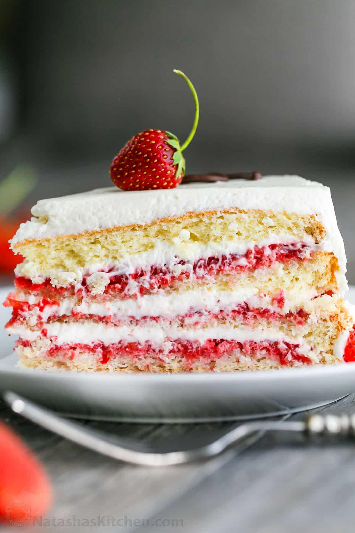 Slice of Strawberry Cake on a plate served with a fork