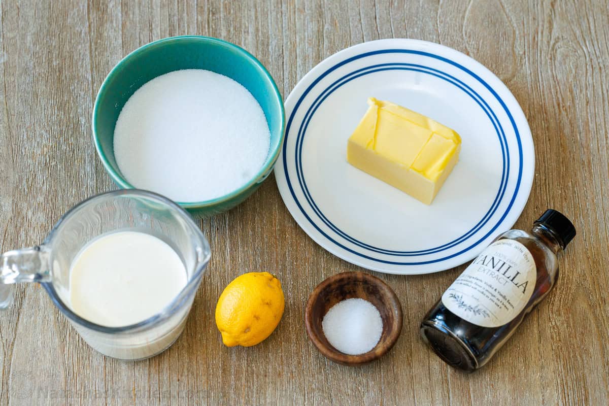 Ingredients for caramel sauce with sugar, butter, cream, lemon juice, vanilla and salt