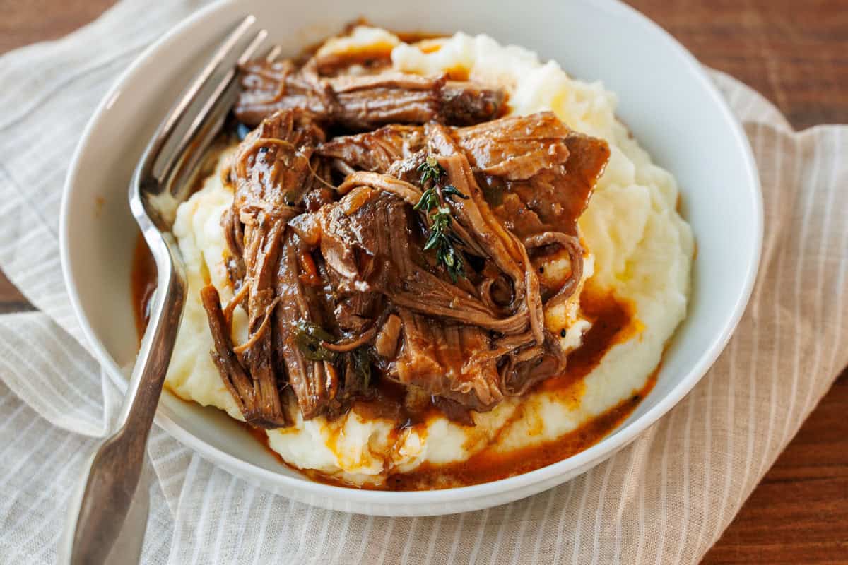 Pot roast in gravy served over mashed potatoes